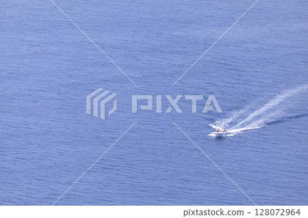 Pleasure boat sailing through Funka Bay, Muroran, Hokkaido [June] 128072964