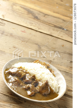 Hot chicken curry with chunks of chicken 128073078