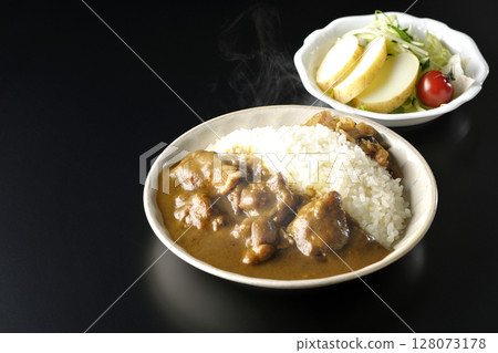 Hot chicken curry with chunks of chicken and potato salad Hot chicken curry with chunks of chicken and potato salad 128073178