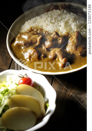Hot chicken curry with chunks of chicken and potato salad Hot chicken curry with chunks of chicken and potato salad 128073186