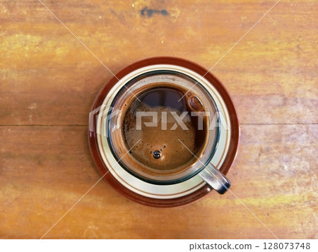 Top view of black coffee. Still life image of black coffee on wood surface Top view of black coffee. Still life image of black coffee on wood surface 128073748