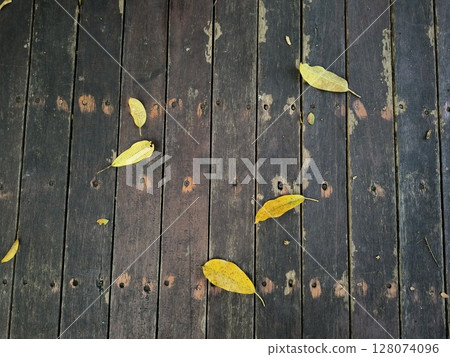 leaves fall on wooden floor, Wooden textured surface with natural leaves background leaves fall on wooden floor, Wooden textured surface with natural leaves background 128074096