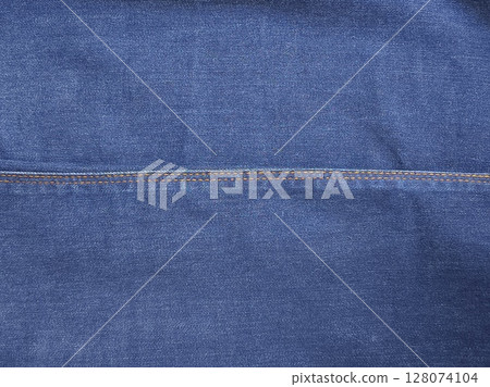 Close-up of blue denim jeans fabric texture background Close-up of blue denim jeans fabric texture background 128074104