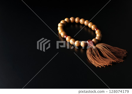 Single shot of prayer beads against a black background Single shot of prayer beads against a black background 128074179
