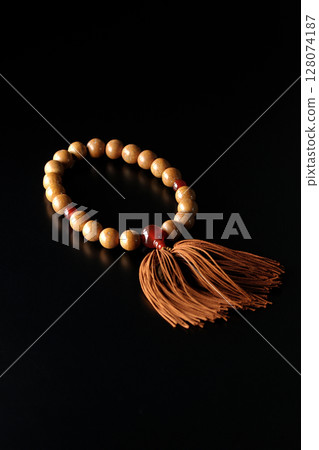Single shot of prayer beads against a black background Single shot of prayer beads against a black background 128074187