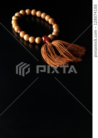 Single shot of prayer beads against a black background 128074188