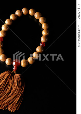 Single shot of prayer beads against a black background 128074197