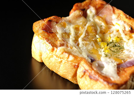 Pizza toast photographed alone on a black background 128075265
