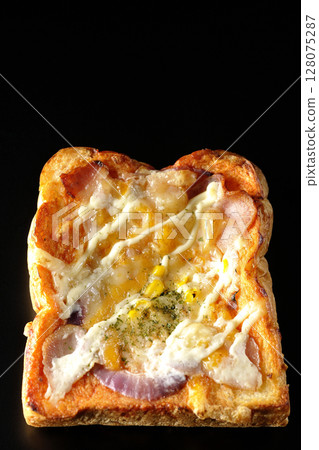 Pizza toast photographed alone on a black background Pizza toast photographed alone on a black background 128075287