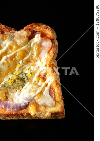 Pizza toast photographed alone on a black background Pizza toast photographed alone on a black background 128075290