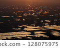 Sunset reflected in the rice paddies 128075975