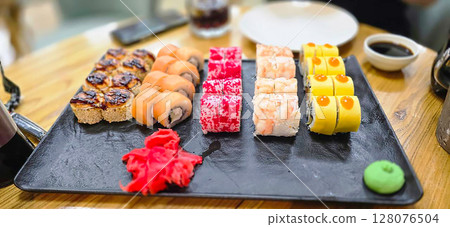 A set of different rolls on a plate in a restaurant A set of different rolls on a plate in a restaurant 128076504