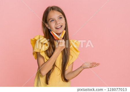 Child girl kid wearing protective mask showing stop hand sign then smiling with relief after removal 128077013