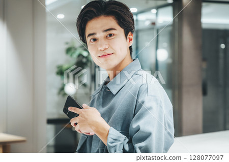 Businessman using a smartphone in the office Photo cooperation: WEEK Shibadaimon (Sun Frontier Fudousan) Businessman using a smartphone in the office Photo cooperation: WEEK Shibadaimon (Sun Frontier Fudousan) 128077097