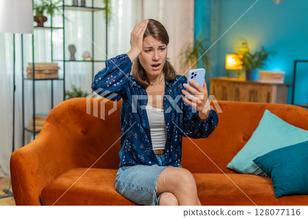 Sad displeased Caucasian woman using smartphone receive bad news, fortune loss fail, deadline, virus 128077116