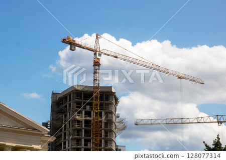 A structure under construction features a crane in the foreground 128077314