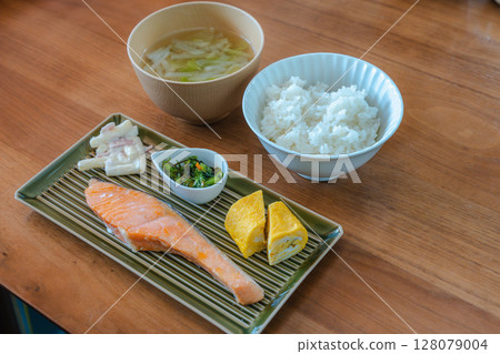 Japanese breakfast of grilled salmon and rolled egg 128079004
