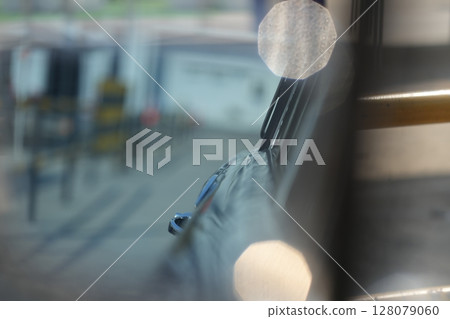 The inner door handles of a vintage car are captured in a clean view, reflecting the classic design and preserved components that represent the simplicity and authenticity of vintage cars. 128079060