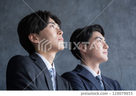 Serious and serious close-up of a business person's profile looking towards the future and goals - Image of a young person or new graduate Serious and serious close-up of a business person's profile looking towards the future and goals - Image of a young person or new graduate 128079855