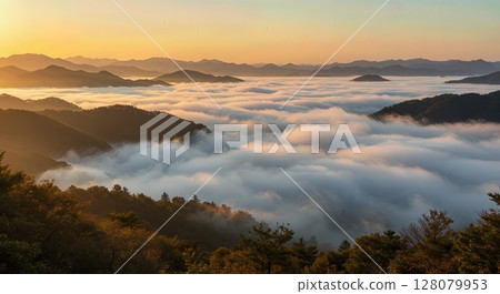 Morning Fog Rolling Through Mountain Valley at Sunrise 128079953