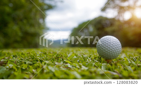 Golf ball on green grass in the evening golf course with sunshine background. 128083820