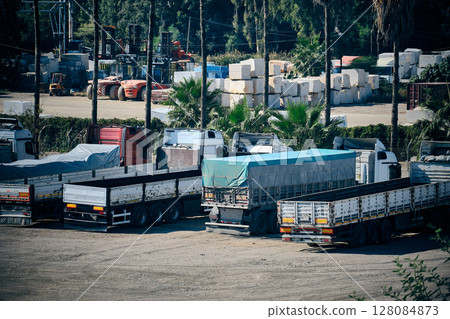 Cargo trucks parked in industrial storage yard Cargo trucks parked in industrial storage yard 128084873