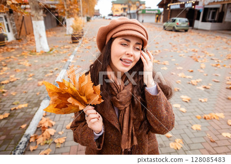 Weekend leisure in the city as a fashionable young woman moves through autumn scenes, soaking up sunlight and enjoying slow living. Top view Weekend leisure in the city as a fashionable young woman moves through autumn scenes, soaking up sunlight and enjoying slow living. Top view 128085483