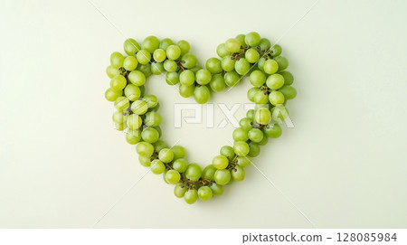 Green grape fruit are arranged in a heart-shaped arrangement copy space 128085984