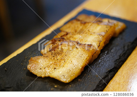 Close-up of Sliced Seasoned Pork Belly on Slate Plate Close-up of Sliced Seasoned Pork Belly on Slate Plate 128086036