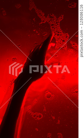 An Artistic Representation of a Hand Emerges Through a Red-Hued Liquid with Bubbles, Evoking Emotions of Depth and Mystery in an Abstract Composition An Artistic Representation of a Hand Emerges Through a Red-Hued Liquid with Bubbles, Evoking Emotions of Depth and Mystery in an Abstract Composition 128086116