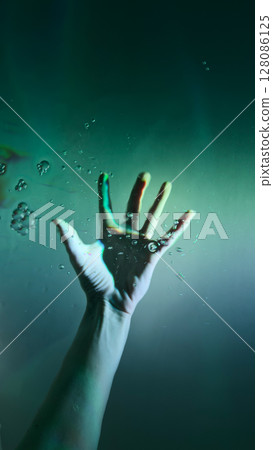 A Captivating Underwater Scene Featuring an Outstretched Hand Reaching Towards the Surface, Surrounded by Bubbles and Soft Light - A Symbol of Struggle and Hope Beneath the Waves A Captivating Underwater Scene Featuring an Outstretched Hand Reaching Towards the Surface, Surrounded by Bubbles and Soft Light - A Symbol of Struggle and Hope Beneath the Waves 128086125