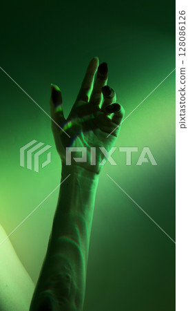 A Dramatic Illumination of a Hand in Green Light: Artistic Capture of Gesture and Shadows Creating Unique Visual Effects A Dramatic Illumination of a Hand in Green Light: Artistic Capture of Gesture and Shadows Creating Unique Visual Effects 128086126