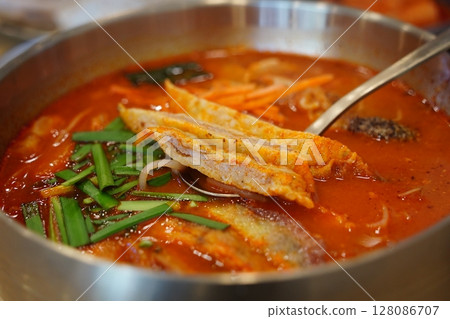 Close-up of Korean Spicy Pork Soup Served in a Traditional Brass Bowl 128086707