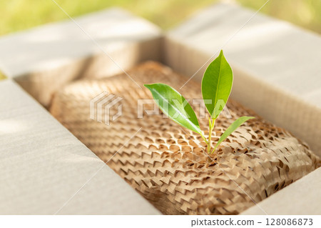 Green leaf on eco friendly brown paper honeycomb wrap for product packaging parcel carton box Green leaf on eco friendly brown paper honeycomb wrap for product packaging parcel carton box 128086873