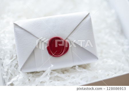 Wax seal stamp on white paper wrap packaging parcel box 128086913