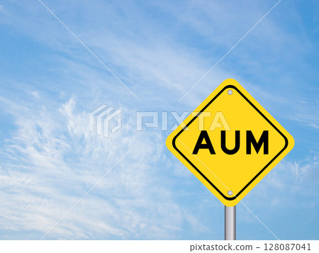 Yellow transportation sign with word AUM (Asset under management) on blue color sky background 128087041