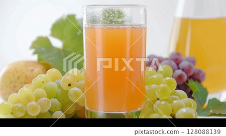 Glass of grape juice with fresh green and yellow grape bunches on white background Glass of grape juice with fresh green and yellow grape bunches on white background 128088139