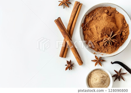 Cinnamon powder, sticks, and vanilla are arranged on a clean surface, showcasing their vibrant textures and natural beauty for culinary uses 128090800