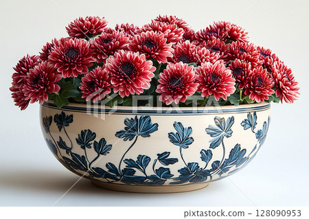Ceramic vase. Close-up. Chrysanthemums bush with fleshy leaves and red flowers. Ceramic vase. Close-up. Chrysanthemums bush with fleshy leaves and red flowers. 128090953