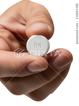 Hand holding single vitamin b6 pill, health supplement isolated on transparent background, nutrition, wellness, dietary aid, pyridoxine for metabolism 128091396