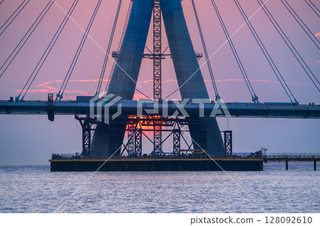 Sunset Through Danjiang Bridge Construction in Tamsui New Taipei City. 128092610