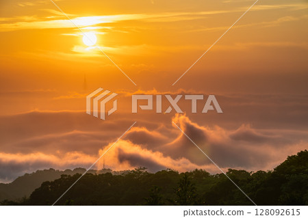 Golden Sunrise Over Wavy Clouds in Shulin Mountains New Taipei City Taiwan. 128092615