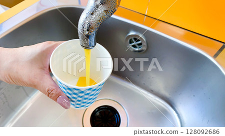 A tap dispensing Ehime mandarin orange juice A tap dispensing Ehime mandarin orange juice 128092686