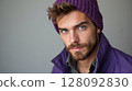 Portrait of a trendy man wearing purple winter clothes and looking at camera 128092830