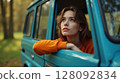 Woman Contemplating Nature from Car Window 128092834