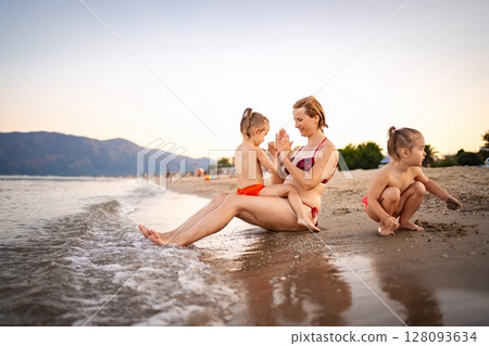 Enjoying a sunny summer day on a Greek beach with kids Enjoying a sunny summer day on a Greek beach with kids 128093634