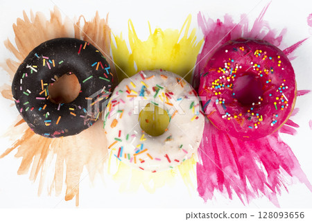 Creative sweet food. A stack of glazed colorful assorted donuts on a bright watercolor painted background. Creative sweet food. A stack of glazed colorful assorted donuts on a bright watercolor painted background. 128093656
