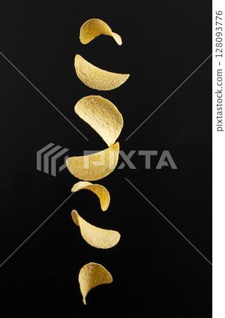 Chips on a black background. Flying potato chips. 128093776