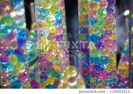 Bright colored balls in glass vessels. 128093812