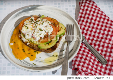 Delicious guacamole toast with fresh tomato and avocado Delicious guacamole toast with fresh tomato and avocado 128094934